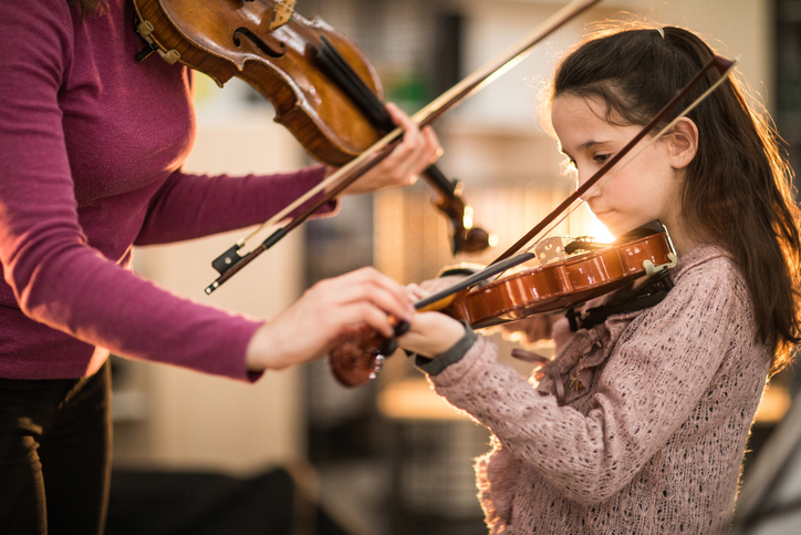 Teacher and student playing violin What To Expect In Your Child’s First Violin Class